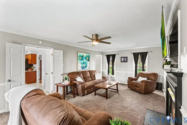 a living room with furniture and wooden floor