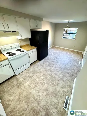 a view of a backyard with plants and a patio