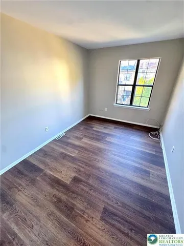 a view of a room with wooden floor
