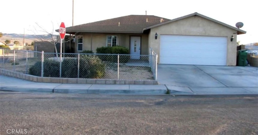 a view of a house with a small yard and plants