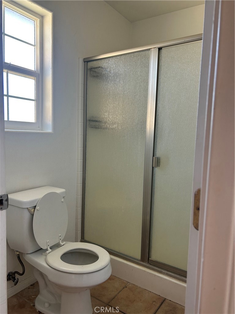 1301 West Willow Avenue Ridgecrest, CA 93555 - Photo 6 of 12 a white toilet sitting next to a shower