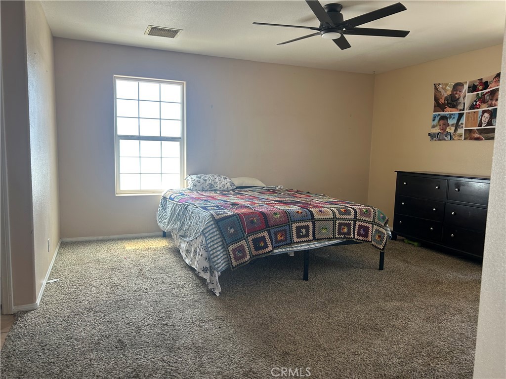 1301 West Willow Avenue Ridgecrest, CA 93555 - Photo 8 of 12 a bedroom with a bed and a window