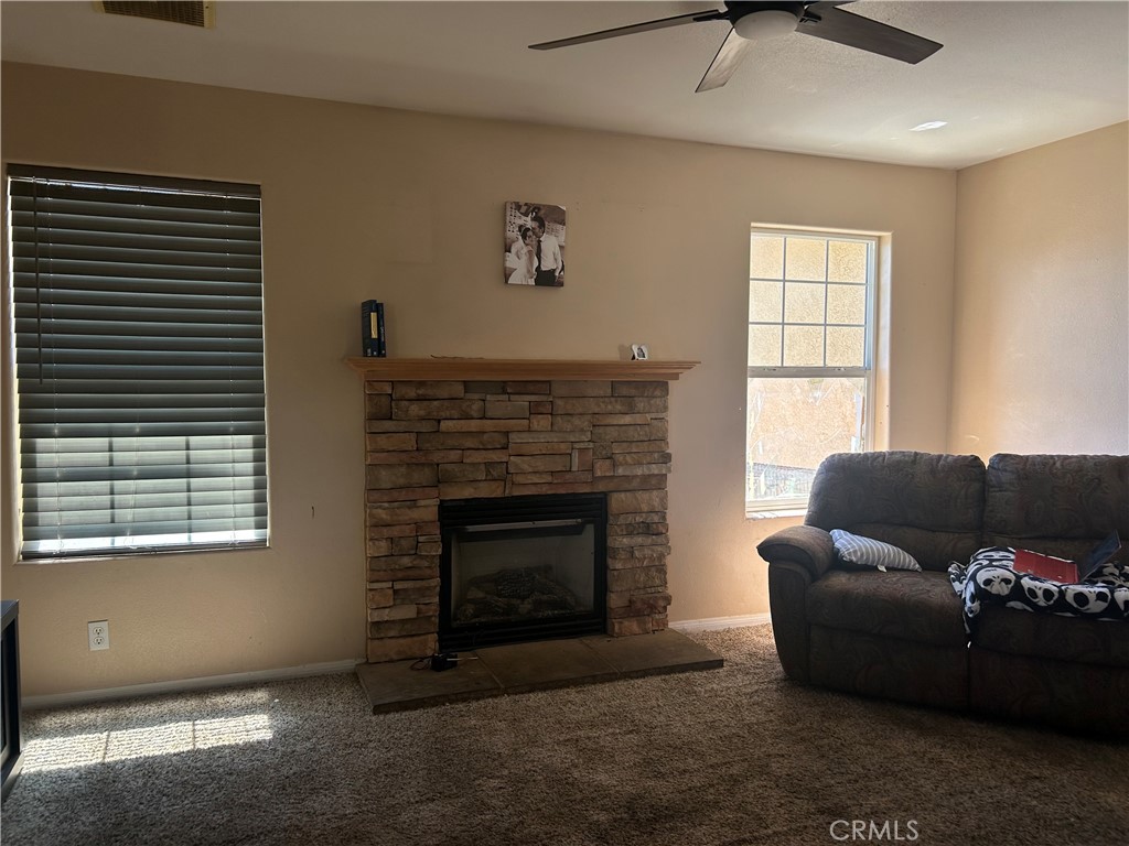 1301 West Willow Avenue Ridgecrest, CA 93555 - Photo 9 of 12 a living room with furniture and a fireplace