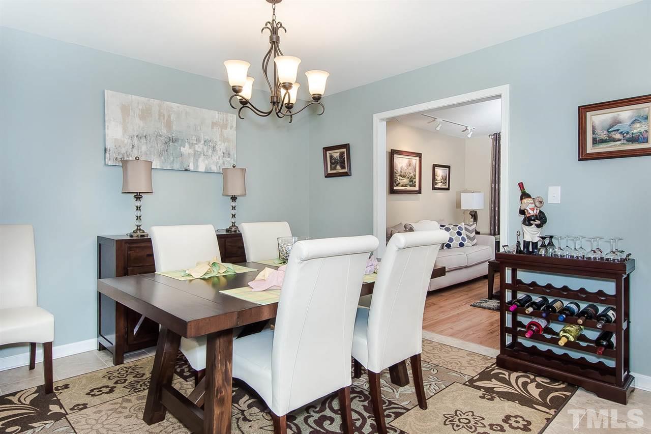 4212 Pickwick Drive Raleigh, NC 27613 - Photo 3 of 8 a view of a dining room with furniture and chandelier