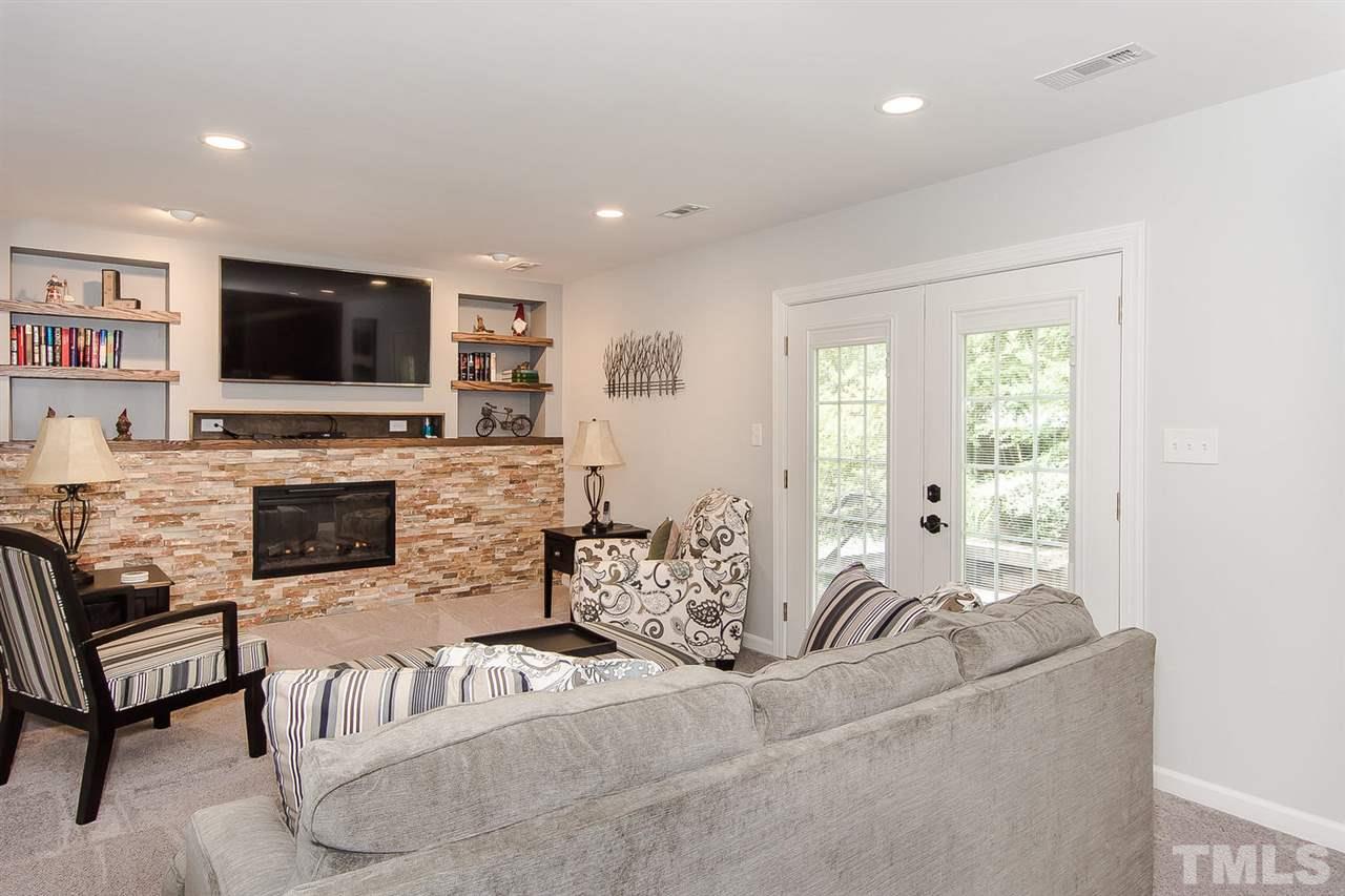 4212 Pickwick Drive Raleigh, NC 27613 - Photo 5 of 8 a living room with furniture and a flat screen tv