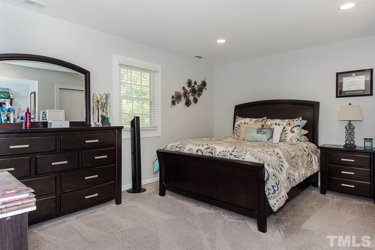 4212 Pickwick Drive Raleigh, NC 27613 - Photo 6 of 8 a bedroom with a bed and a dresser