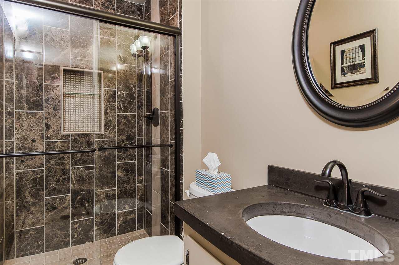 4212 Pickwick Drive Raleigh, NC 27613 - Photo 7 of 8 a bathroom with a sink a toilet and shower