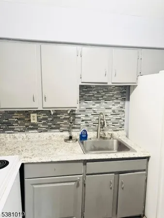a kitchen with a sink and cabinets