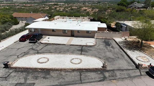 an aerial view of a house with pool table and chairs