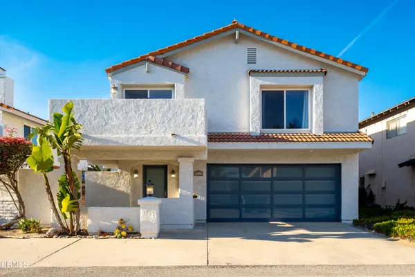 a view of a house with a yard and garage