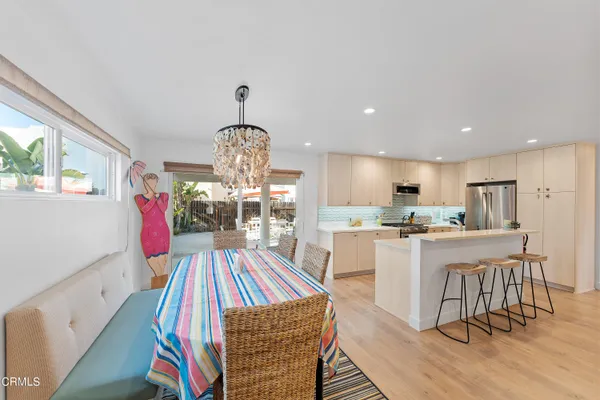 a living room with dining room and wooden floor