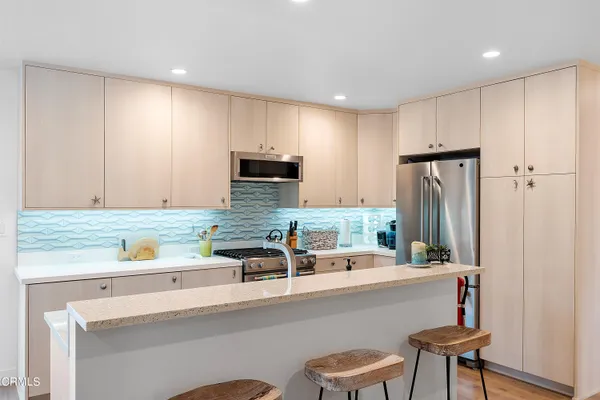 a kitchen with a sink cabinets and window