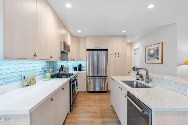 a kitchen with a sink stove and refrigerator
