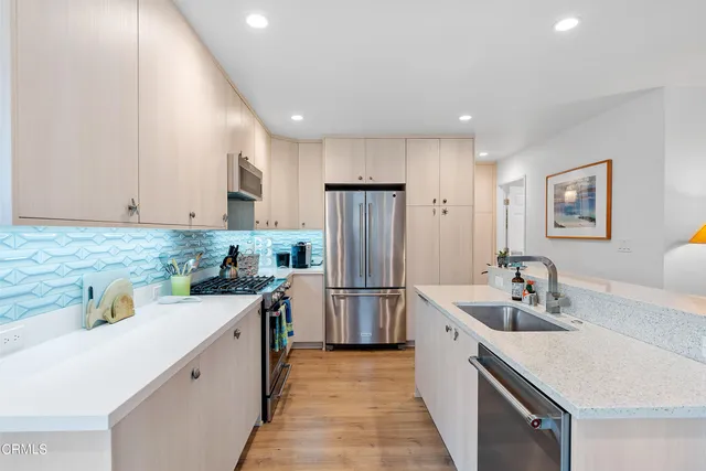 a kitchen with a sink stove and refrigerator