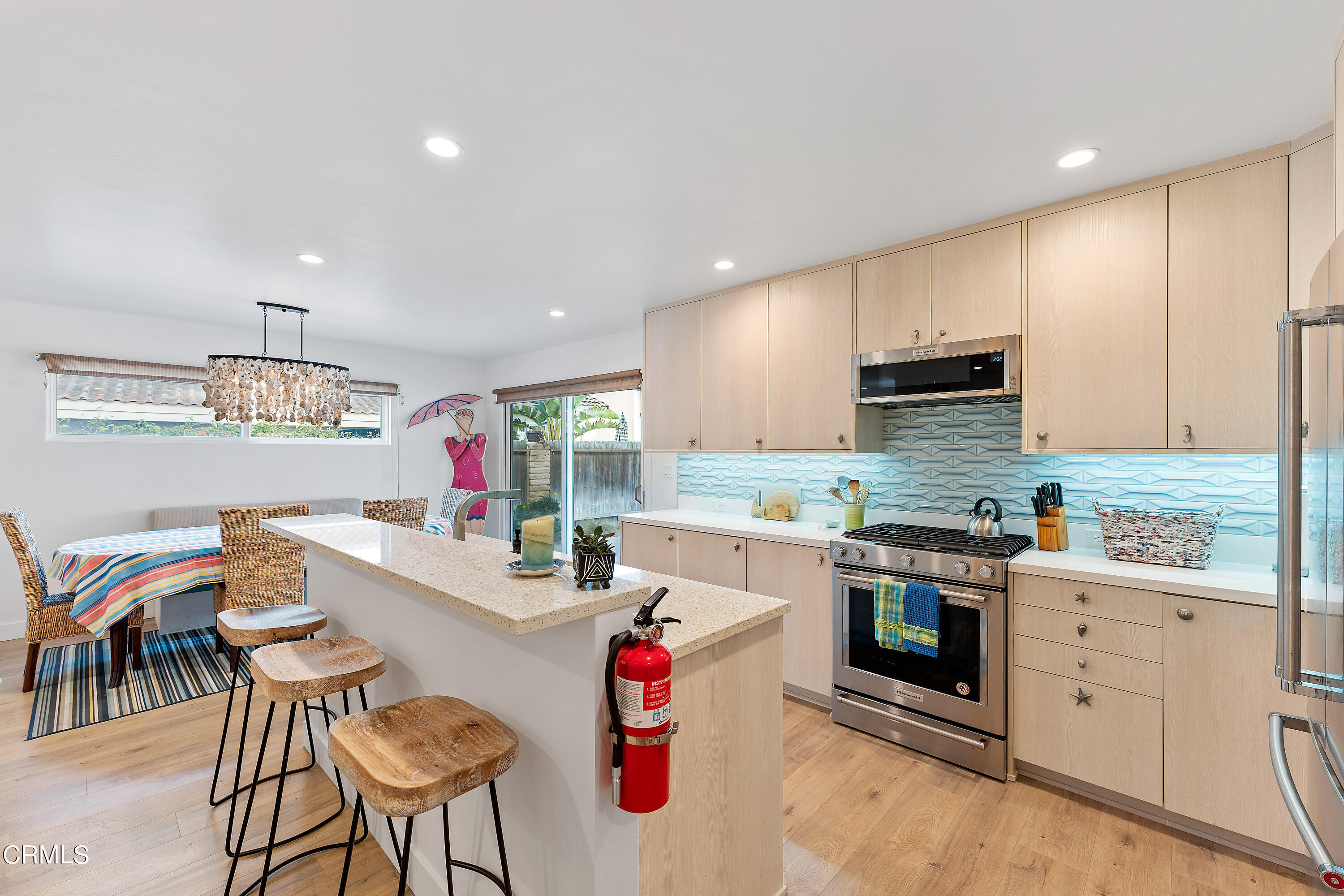 5207 Sealane Way Oxnard, CA 93035 - Photo 19 of 45 a kitchen that has cabinets a sink and a stove with chairs