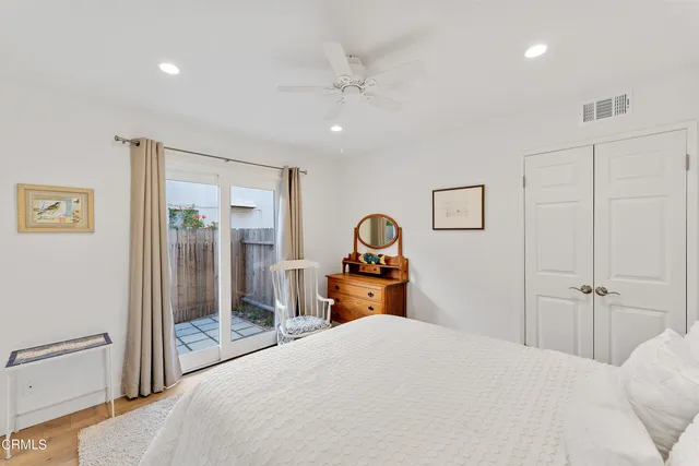 a bedroom with a bed and a large mirror