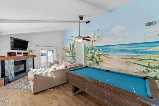 a living room with furniture flat screen tv and a fireplace