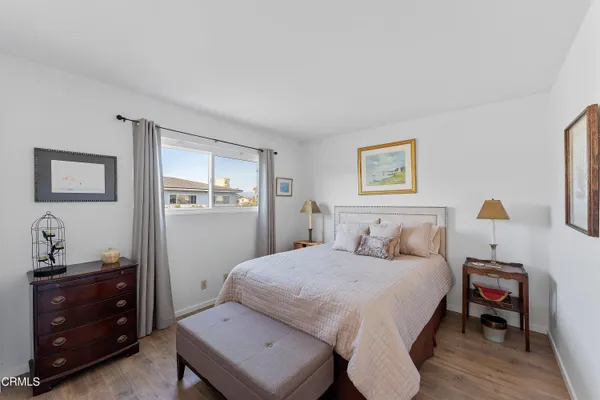 a bedroom with a bed and a dresser in it