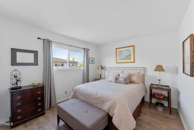 a bedroom with a bed and a dresser in it