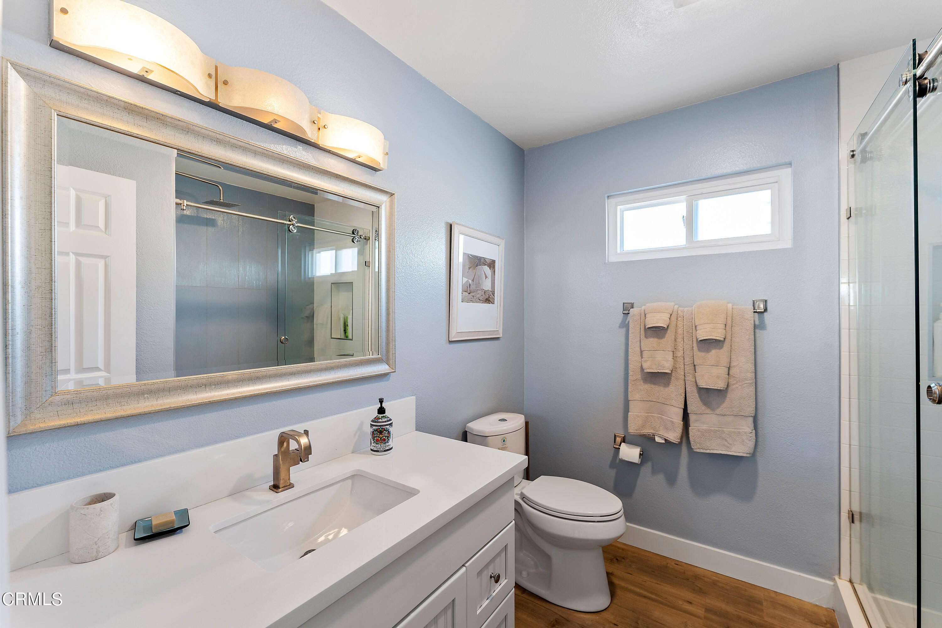 5207 Sealane Way Oxnard, CA 93035 - Photo 30 of 45 a bathroom with a sink vanity mirror and toilet