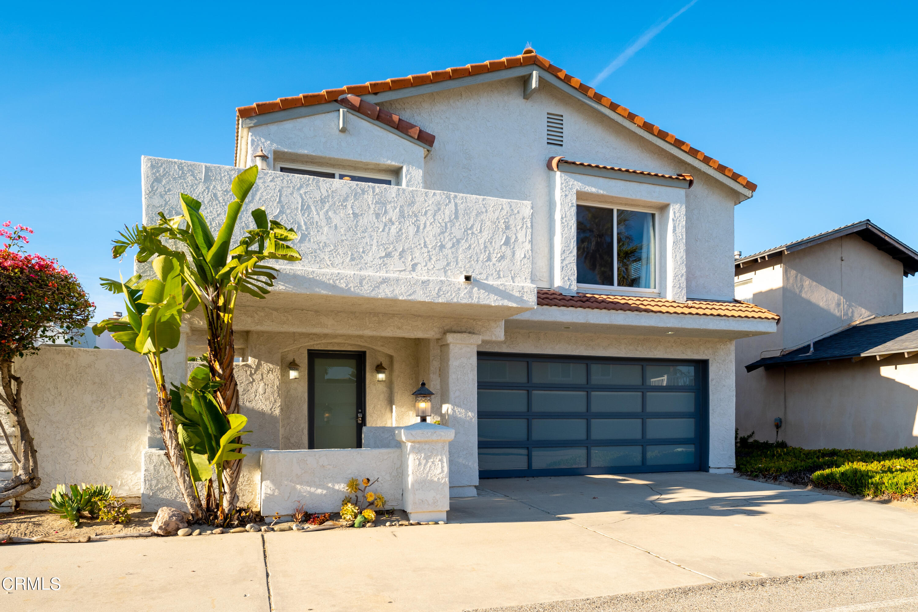 5207 Sealane Way Oxnard, CA 93035 - Photo 3 of 45 a front view of a house with a yard and garage