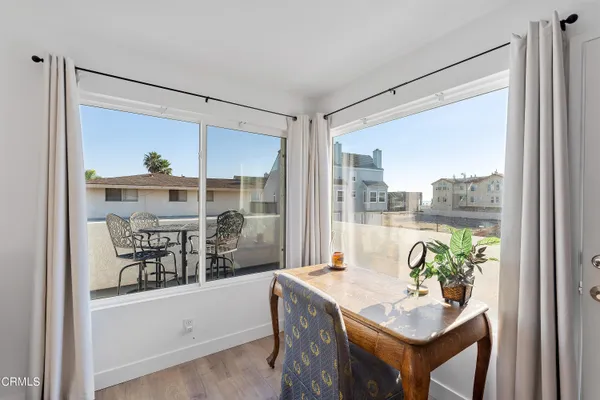 a very nice looking dining room with a large window and dining table