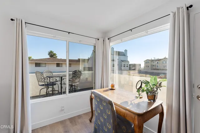 a very nice looking dining room with a large window and dining table