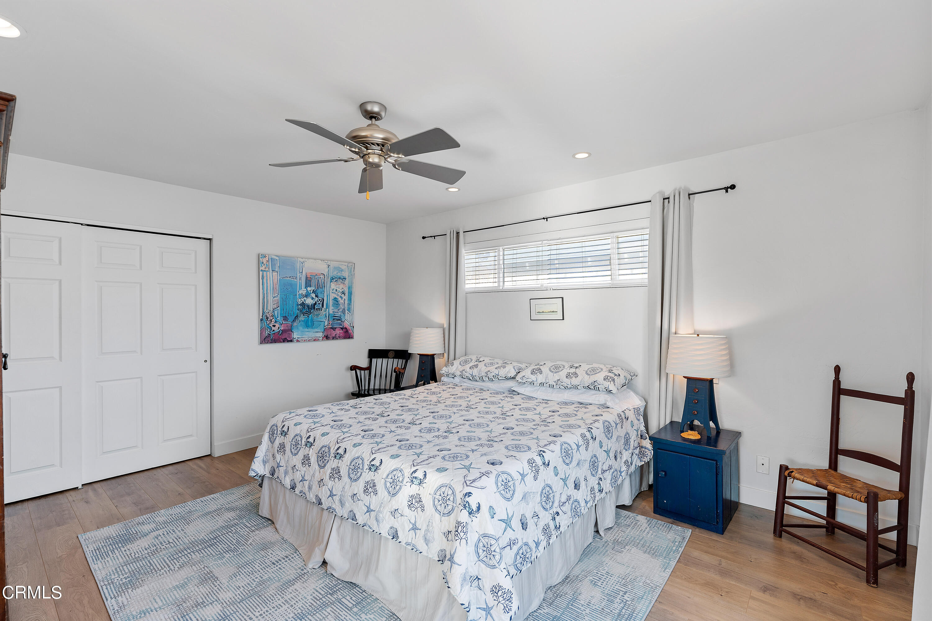 5207 Sealane Way Oxnard, CA 93035 - Photo 34 of 45 a bedroom with a bed and a chandelier