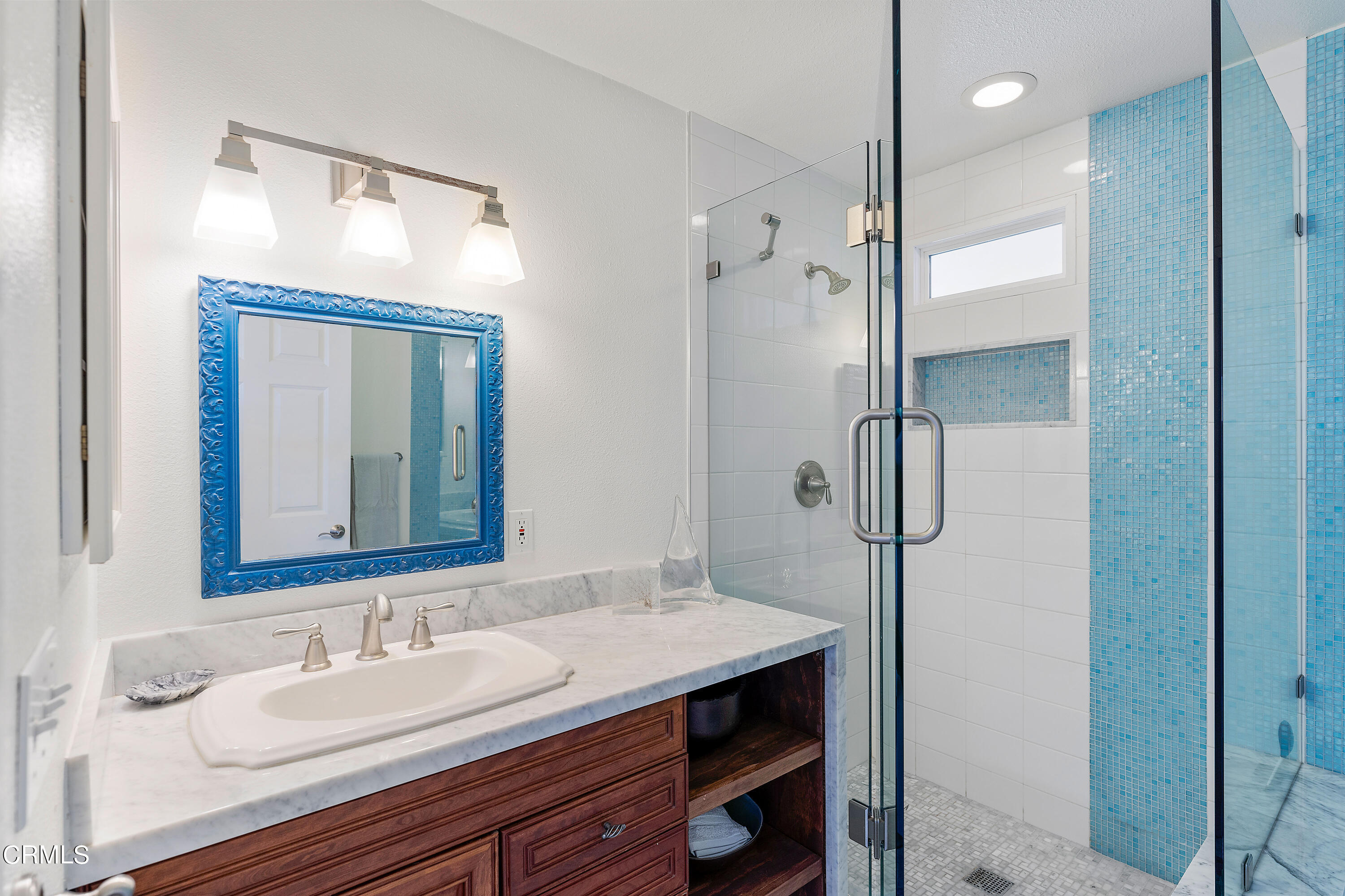 5207 Sealane Way Oxnard, CA 93035 - Photo 36 of 45 a bathroom with a granite countertop sink mirror and a shower