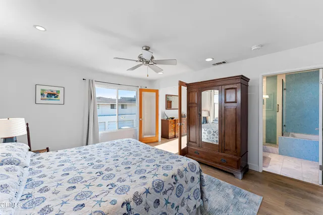 a bedroom with a large bed and a chandelier