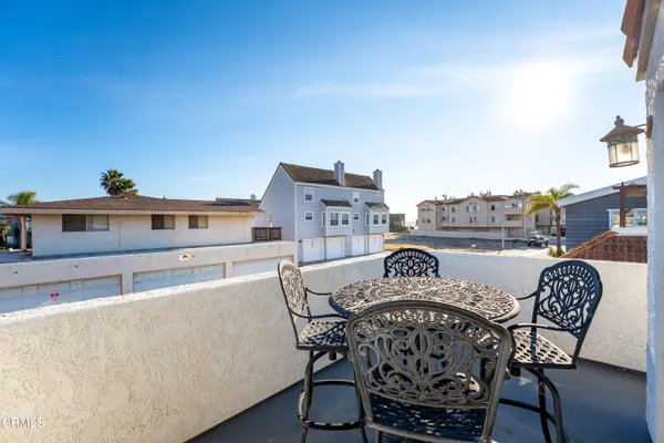 a view of a roof deck with furniture