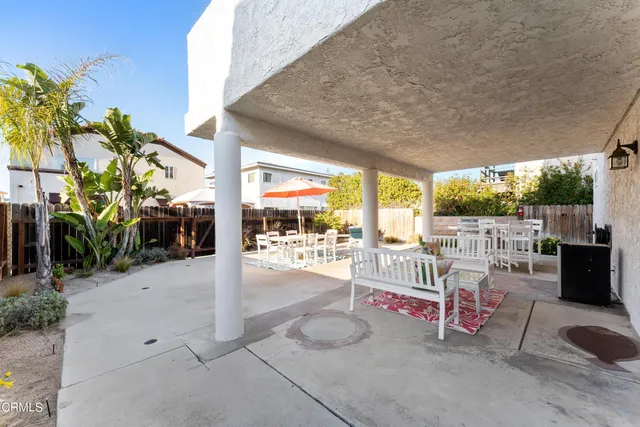a building outdoor space with patio furniture and potted plants