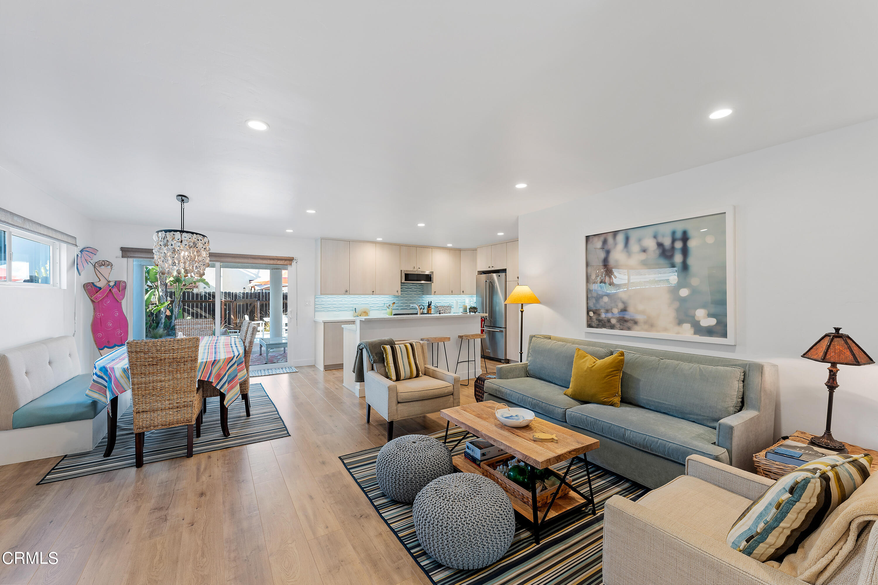 5207 Sealane Way Oxnard, CA 93035 - Photo 7 of 45 a living room with furniture and a dining table with wooden floor