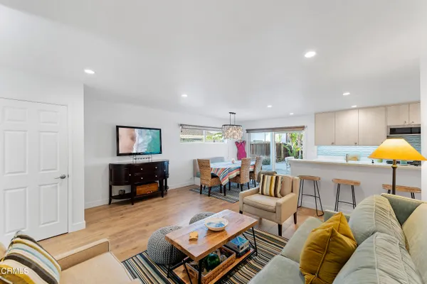 a living room with furniture kitchen view and a table