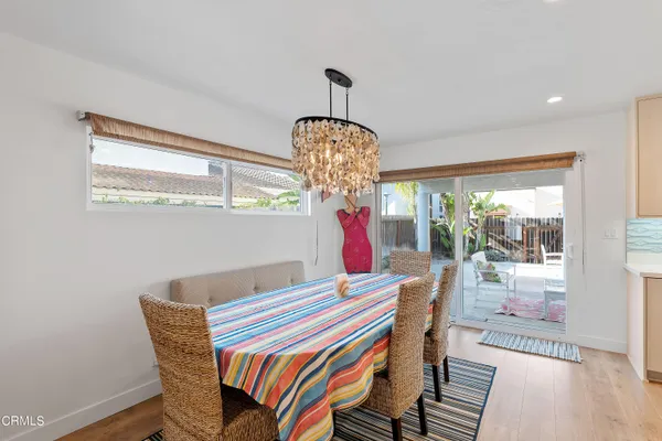 a room with chandelier fan and windows
