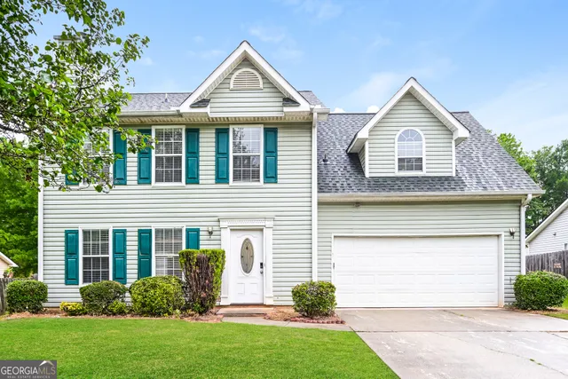 a front view of a house with garden