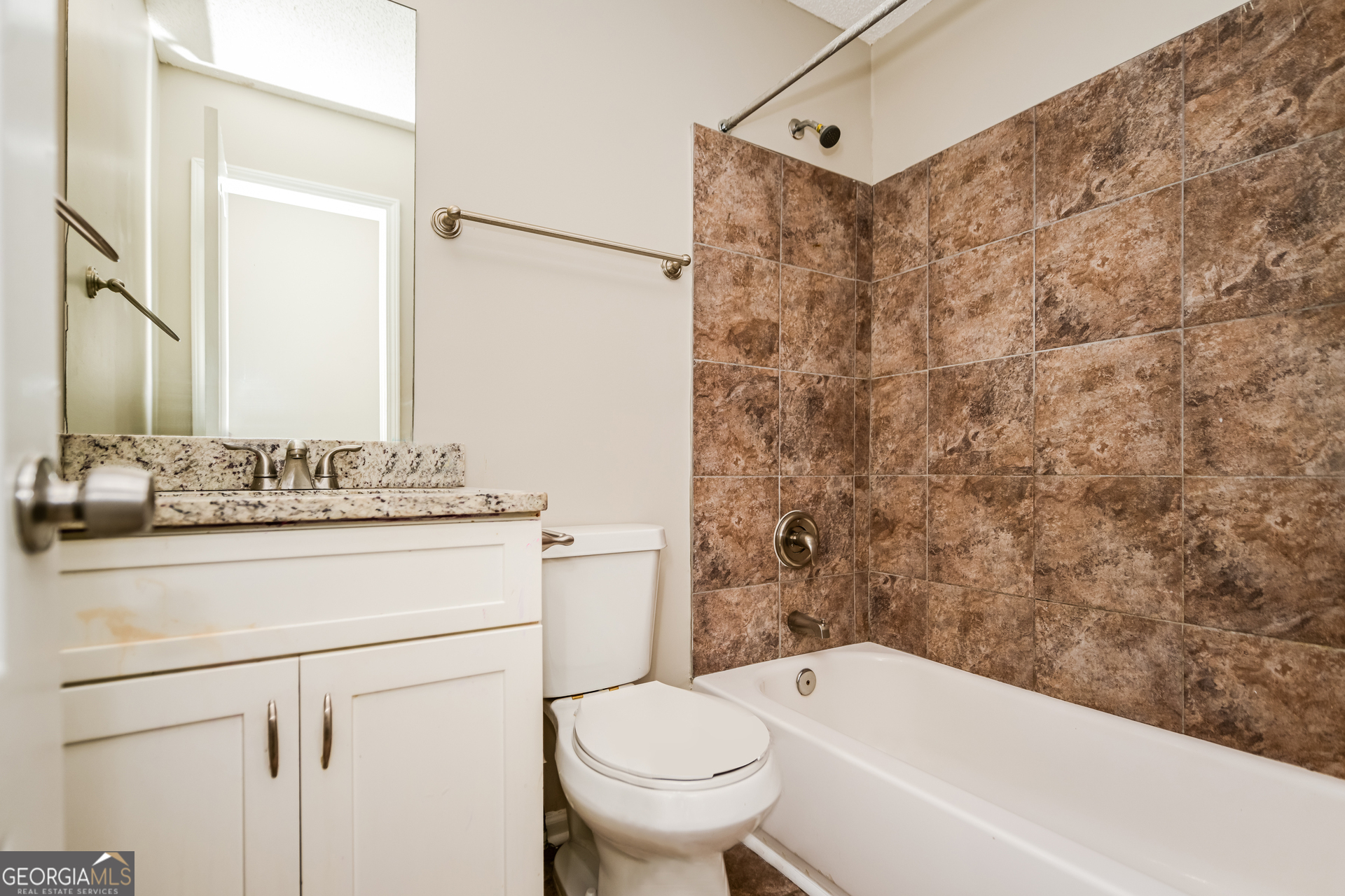 10253 Commons Crossing Jonesboro, GA 30238 - Photo 14 of 17 a bathroom with a toilet sink and mirror