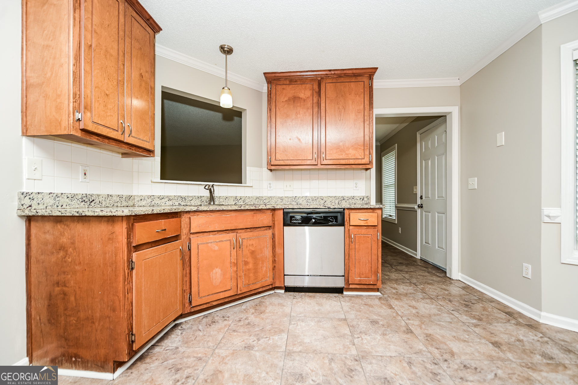 10253 Commons Crossing Jonesboro, GA 30238 - Photo 4 of 17 a kitchen with granite countertop cabinets stainless steel appliances a sink and a window