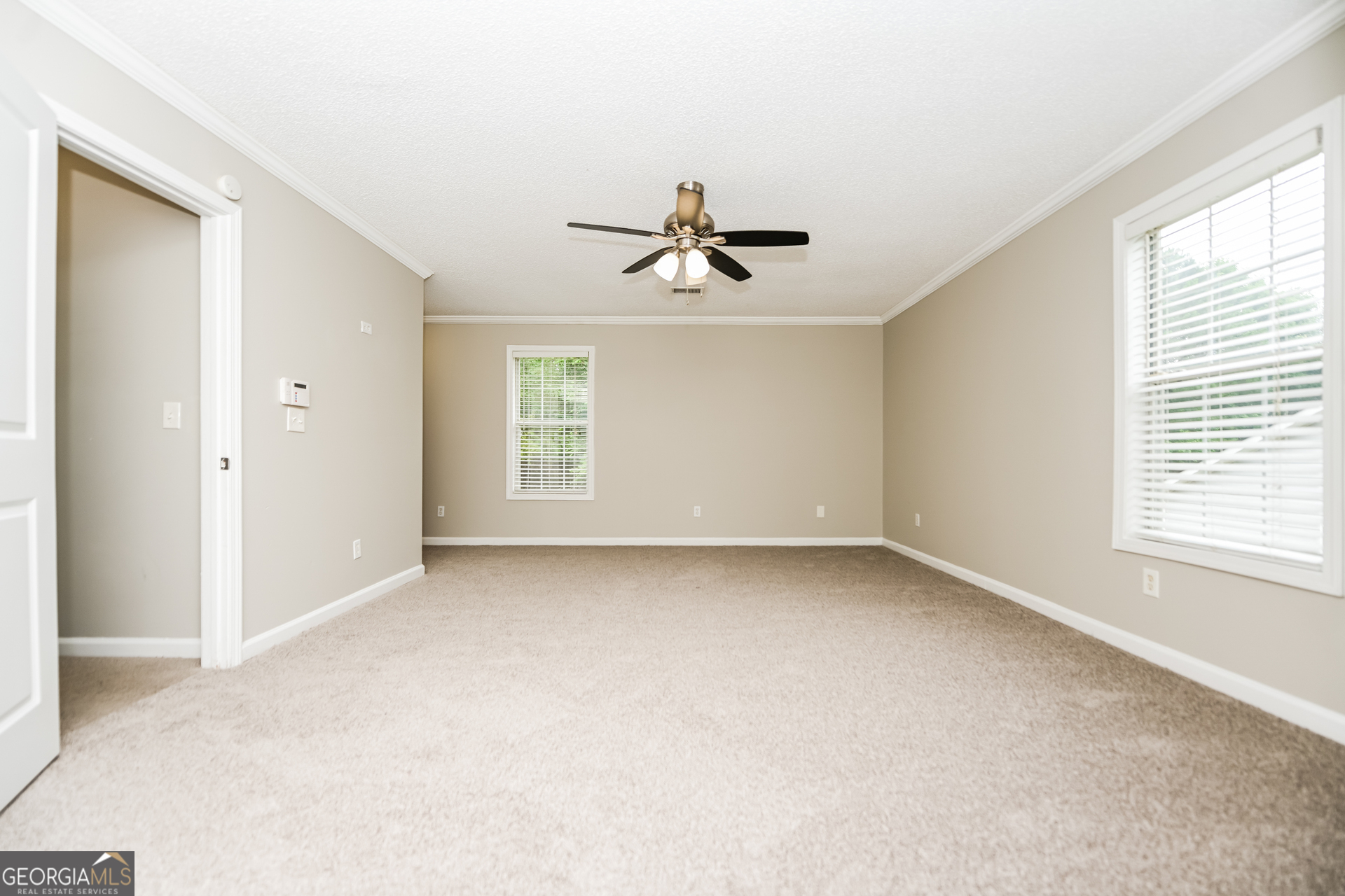 10253 Commons Crossing Jonesboro, GA 30238 - Photo 7 of 17 a view of a livingroom with a ceiling fan and window