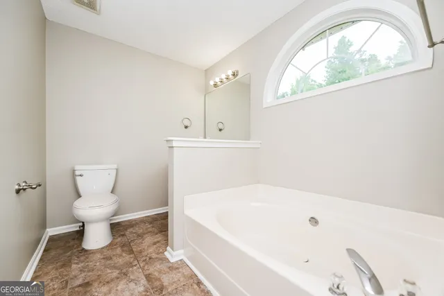 a bathroom with a toilet sink and tub
