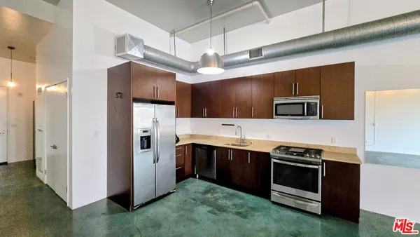 a kitchen with stainless steel appliances a stove a sink and a refrigerator