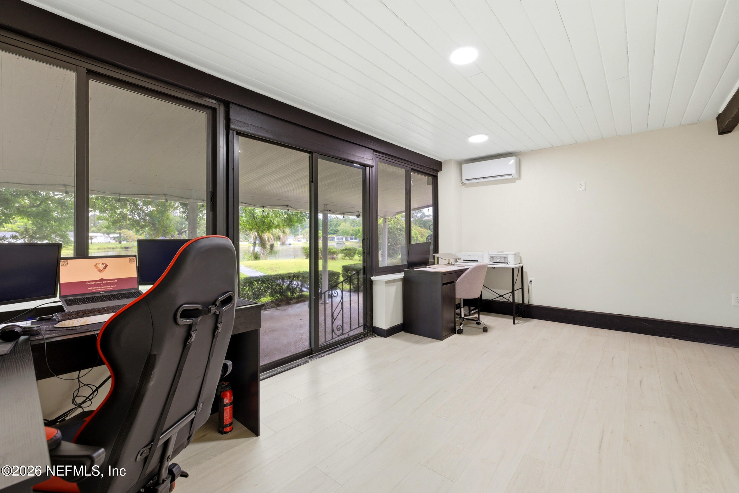 7484 Spinola Road Jacksonville, FL 32217 - Photo 43 of 63 a view of a workspace with furniture and a window