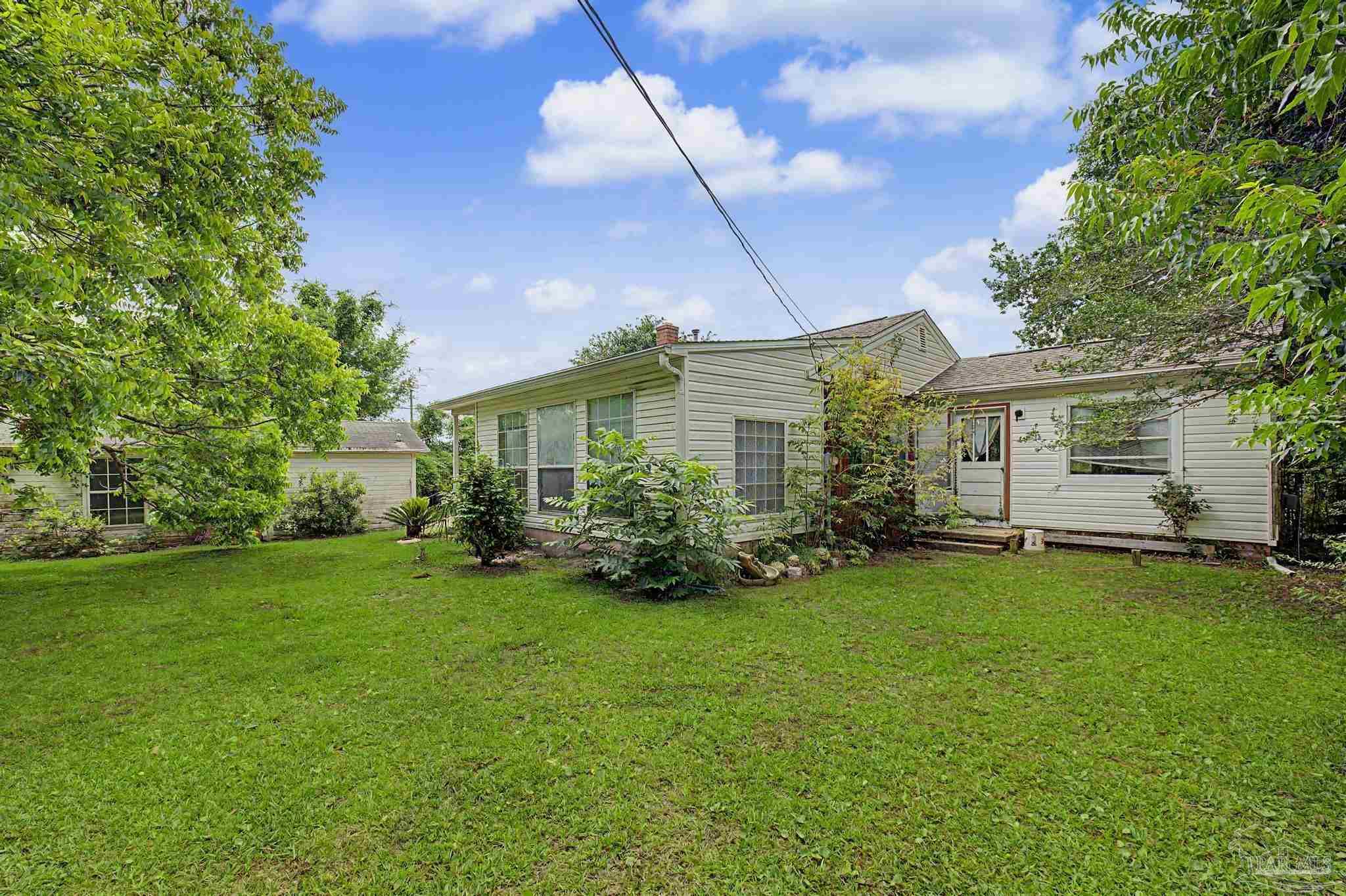 333 Gibbs Road Pensacola, FL 32507 - Photo 31 of 34 a view of a house with a yard and sitting area