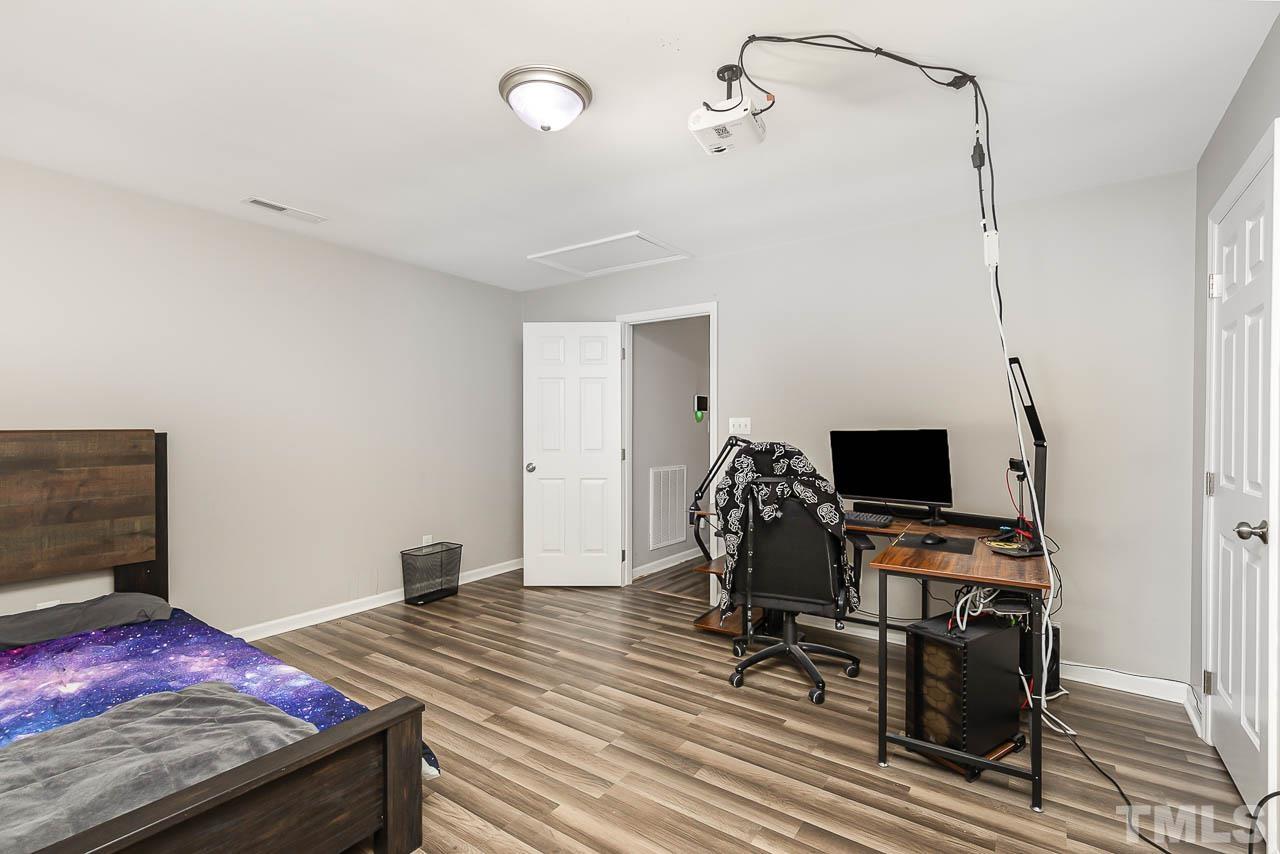 5708 Brandycrest Drive Raleigh, NC 27610 - Photo 11 of 31 a bedroom with a bed and a flat screen tv
