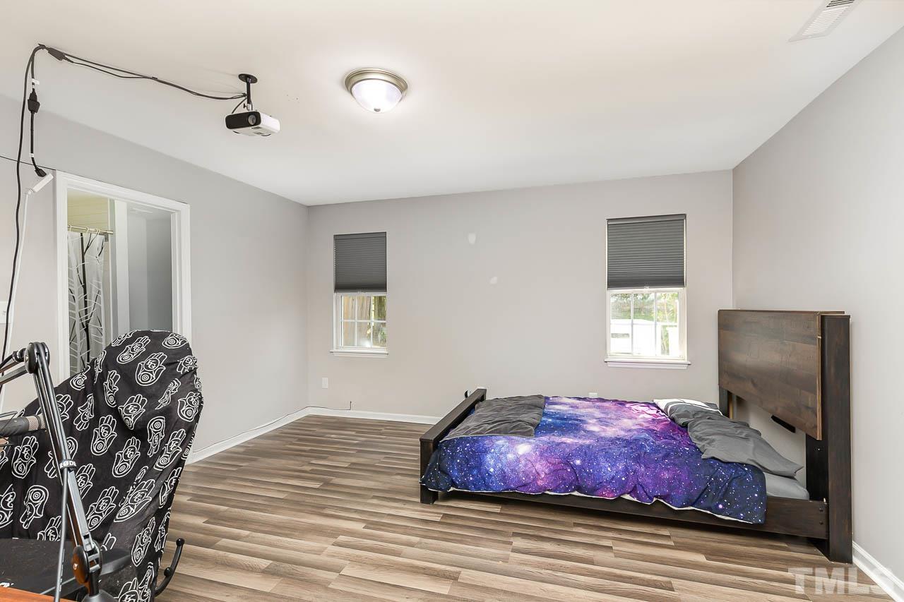 5708 Brandycrest Drive Raleigh, NC 27610 - Photo 12 of 31 a bedroom with furniture and a flat screen tv