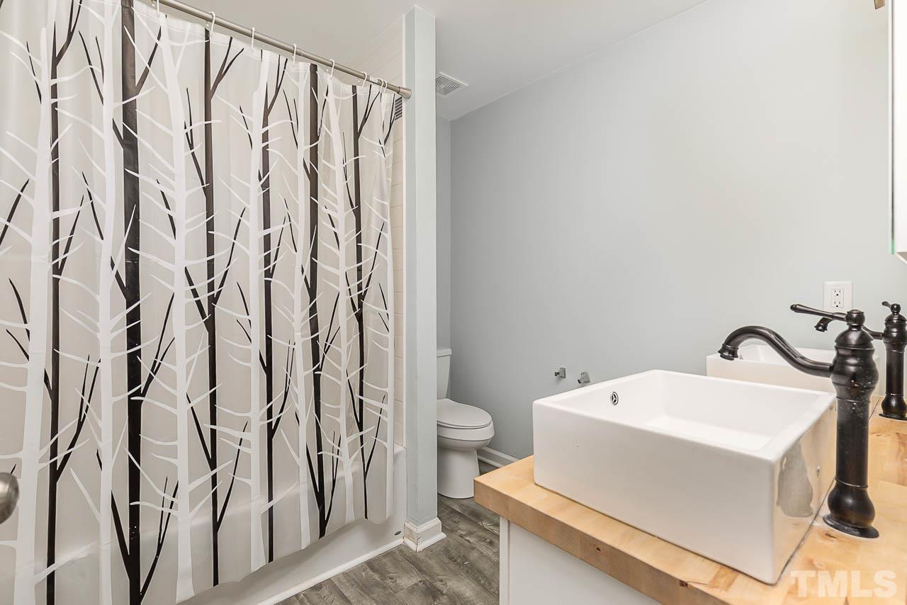 5708 Brandycrest Drive Raleigh, NC 27610 - Photo 14 of 31 a bathroom with a sink and toilet