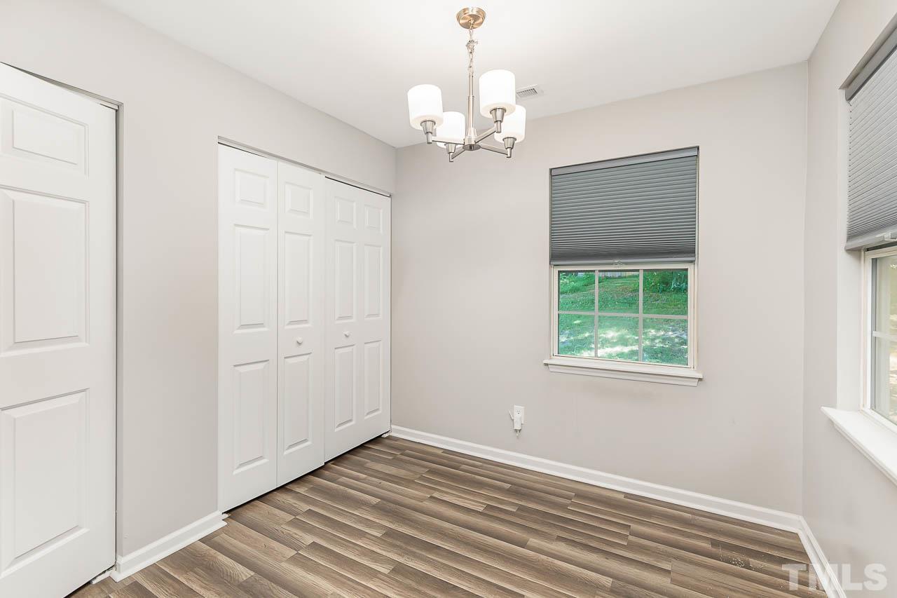 5708 Brandycrest Drive Raleigh, NC 27610 - Photo 15 of 31 a view of a chandelier in a room with a window