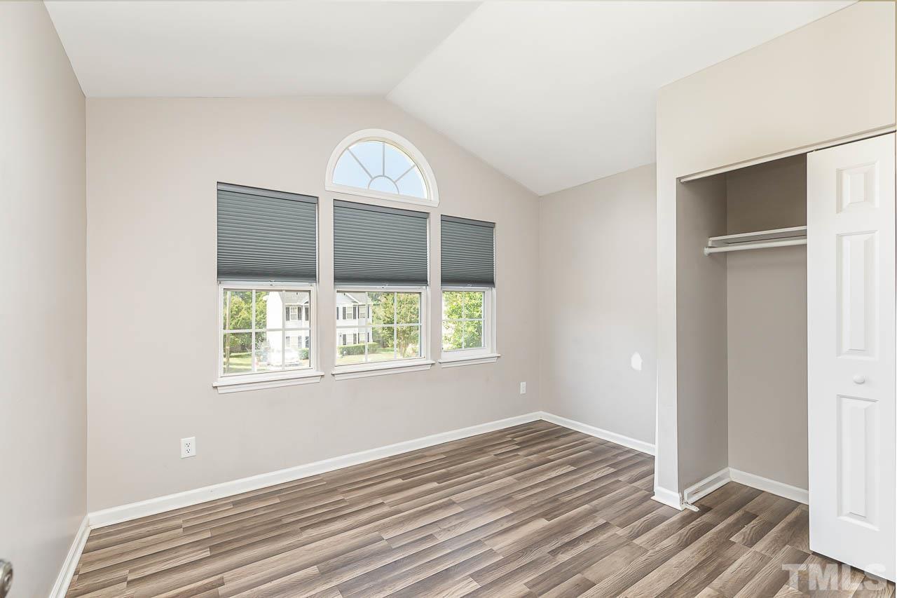 5708 Brandycrest Drive Raleigh, NC 27610 - Photo 18 of 31 a view of an empty room with wooden floor and a window