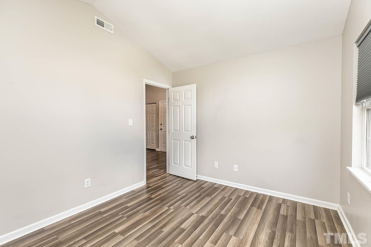 5708 Brandycrest Drive Raleigh, NC 27610 - Photo 19 of 31 a view of an empty room with wooden floor and a window