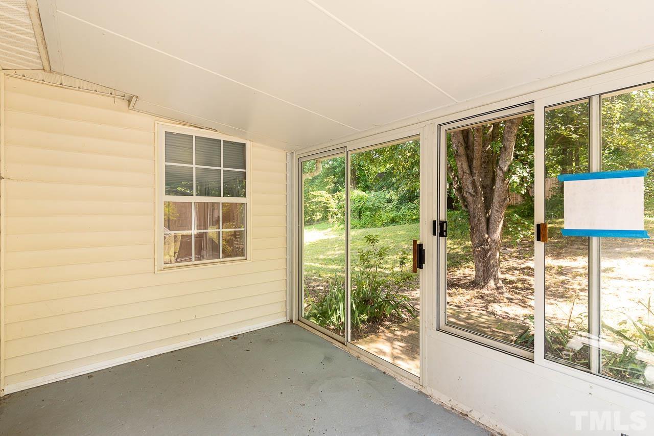 5708 Brandycrest Drive Raleigh, NC 27610 - Photo 21 of 31 an empty room with wooden floor and windows